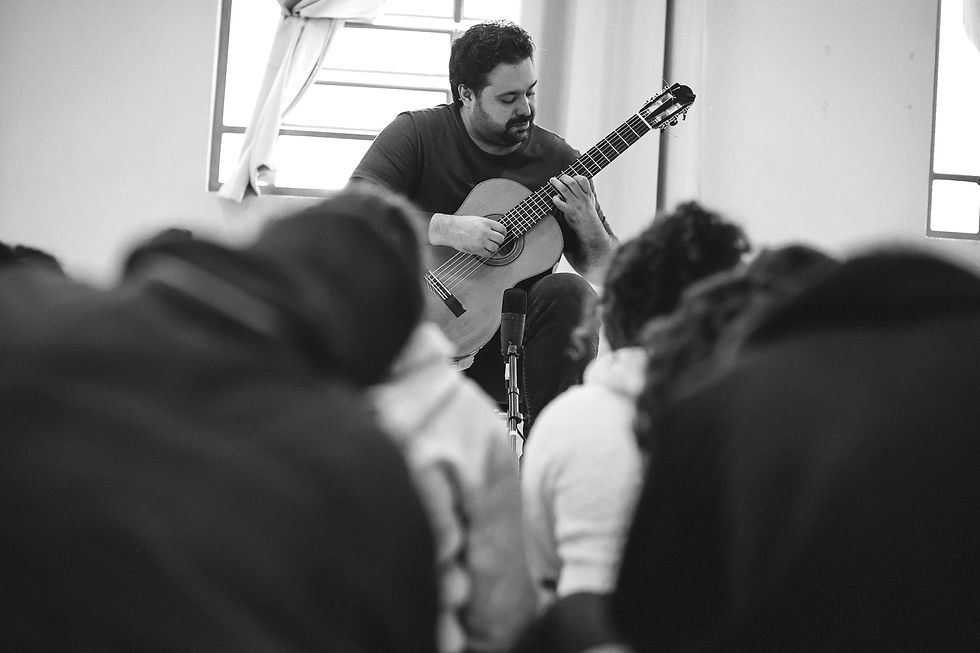 Músico tocando para patrocinadores do Violão na Escola.