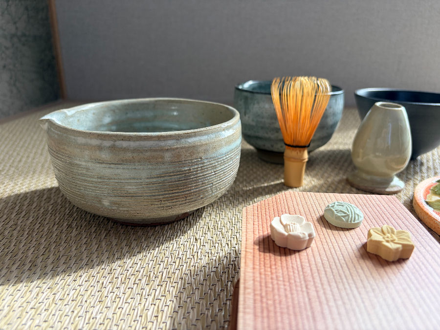 Tominaga Yasuo katakuchi matcha bowl with bamboo chasen whisk on tatami — Genyou Kiln Japan