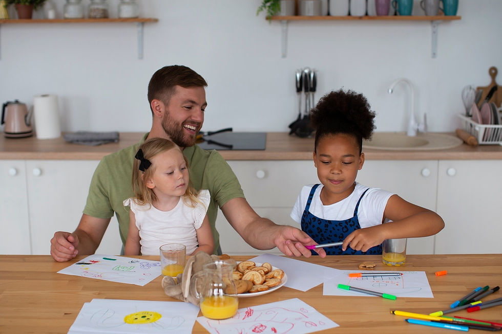 father and daughters at table
