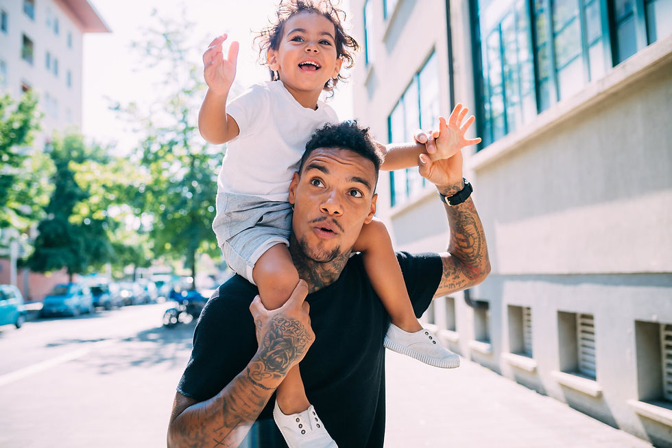 father holding son on his shoulders

