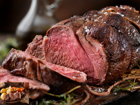 A perfectly roasted beef dish garnished with herbs and vegetables.