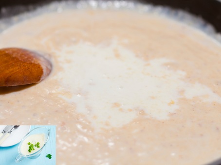 Creamy sauce stirred in a pan with a wooden spoon. Small inset shows white sauce garnished with parsley on blue table.