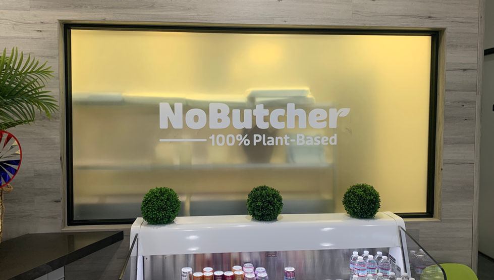 Window signage featuring the NoButcher logo and bold, recognizable brand system.