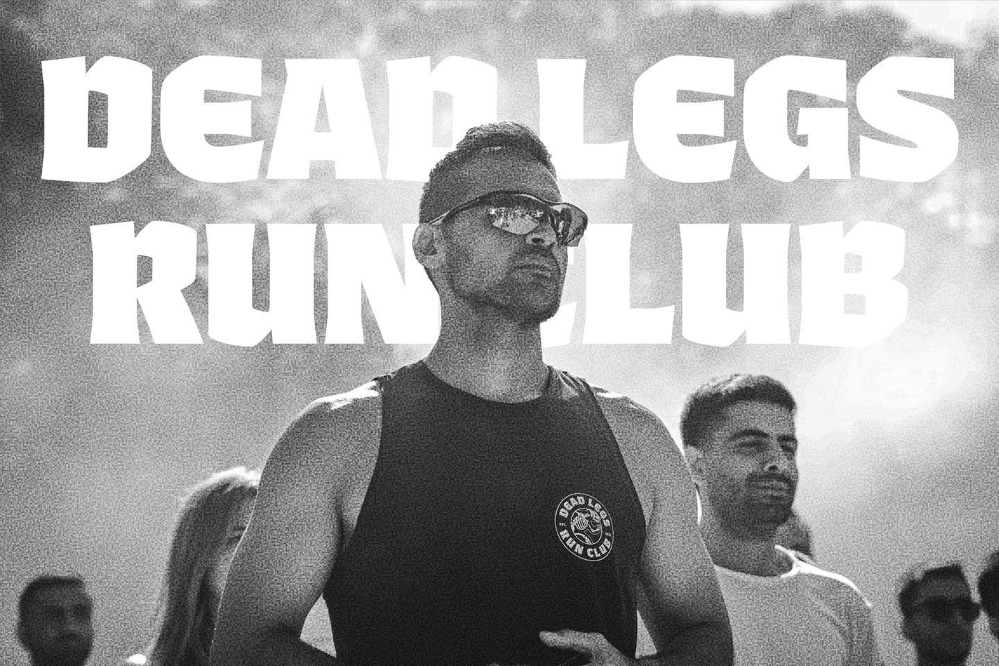 Group photo of Dead Legs Run Club members with the club name displayed in the background, showing community branding by Overland Design Co based in Las Vegas.