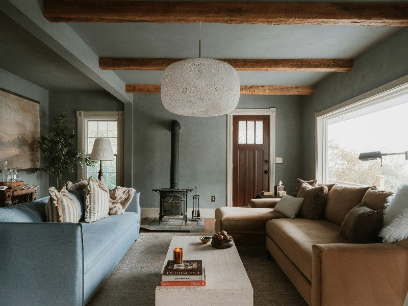 Cozy living room styled with custom light blue sofa upholstery fabric and striped throw pillows sourced from Dallas Home Fabric Center.