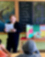 Confident student presenting a creative project in a classroom at Nevada Sage Waldorf School, showcasing public speaking and critical thinking skills.