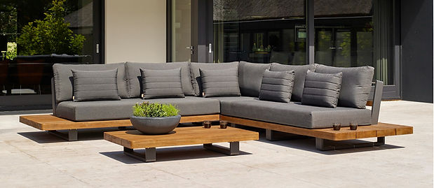 Luxurious outdoor sectional sofa with plush grey cushions and a wooden base, complemented by a low wooden coffee table, showcasing elegant outdoor living.