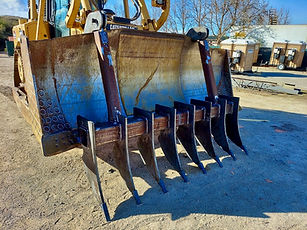 Rebuilt excavator bucket after heavy equipment repair