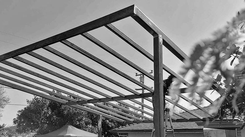 Steel pergola frame against the sky