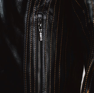 Zipper and hand-cut gold leather piping detail on JPS Special racing jacket