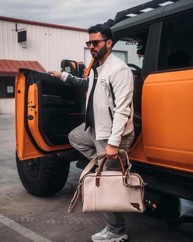 mens white bespoke leather jacket and white leather bag