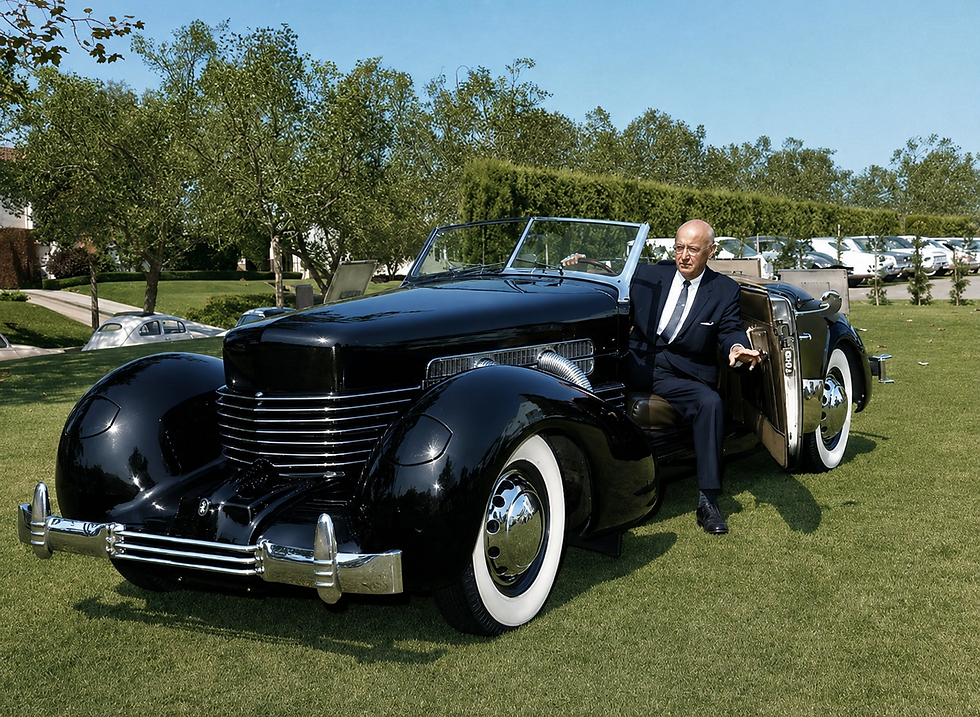Gordon Buehrig seated beside a 1937 Cord 812 Supercharged Phaeton