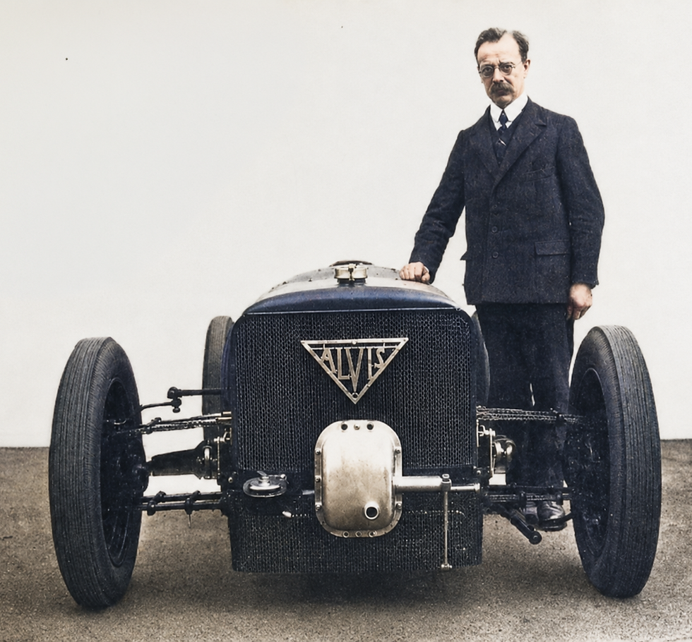 Captain G. T. Smith-Clarke stands beside Alvis’s remarkably low-slung 1927 straight-eight front-wheel-drive Grand Prix racer, one of the experimental cars that helped shape the company’s later production FWD models.