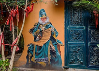 Colorful street art mural in George Town, Penang, featuring expressive and detailed artwork on an old wall, capturing the creative spirit and cultural essence of the city’s heritage area.