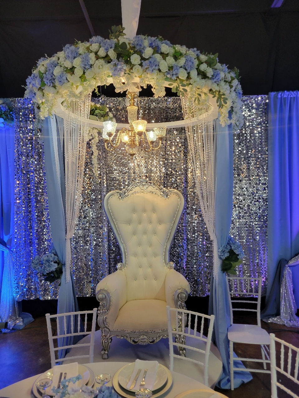 White throne chair under blue floral canopy... we have an amazing team of decorators!