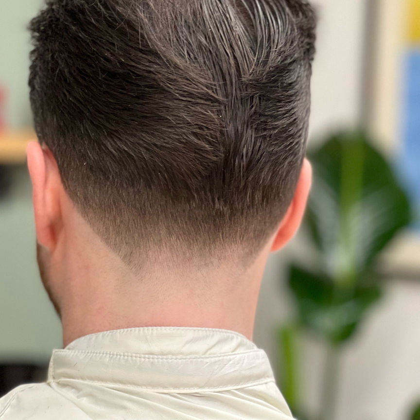 Hair styled back with taper fade, back view