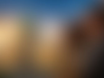 Manitoba Legislative Building with its green copper dome at golden hour alongside a hopeful immigrant professional, symbolizing a new beginning through the Manitoba Provincial Nominee Program