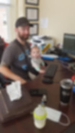 Owner and son at desk