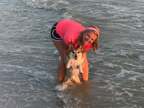 Heidi with her Corgi in the ocean