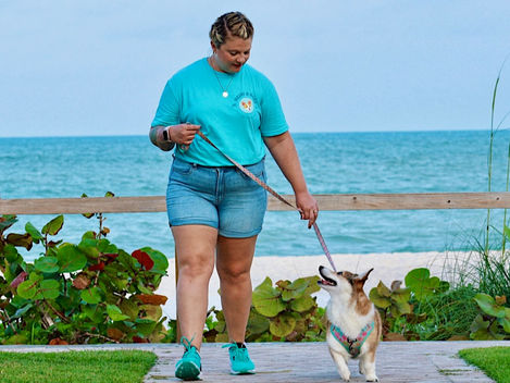 Heidi walking her Corgi by the beach.