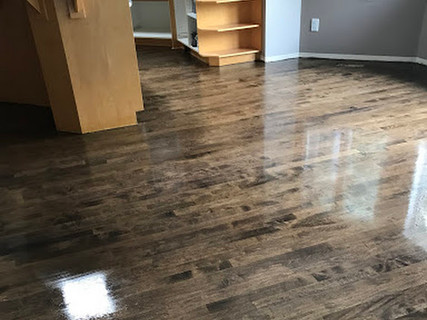 Maple hardwood floor which has been sanded And stained the colour of Jacobean with a satin finish