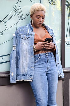 black woman wearing a Canadian suit looking at phone messages