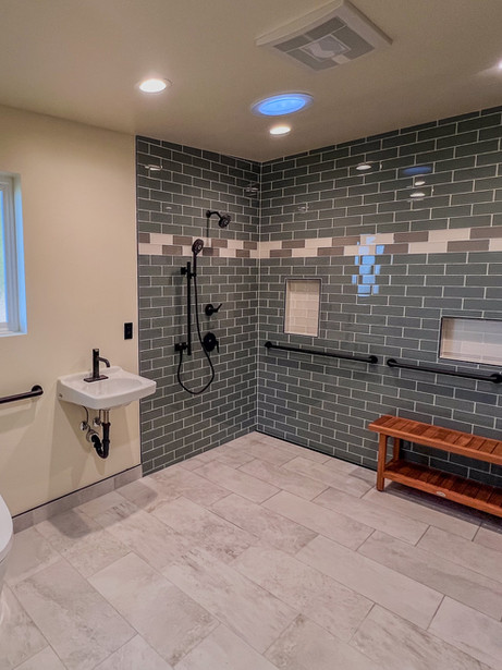 a tile bathroom with a toilet a sink and a walk in shower