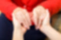 Close up of 2 people holding hands