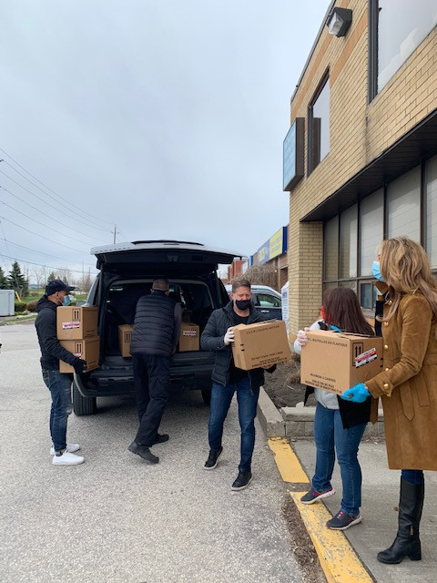 People outside moving boxes full of food
