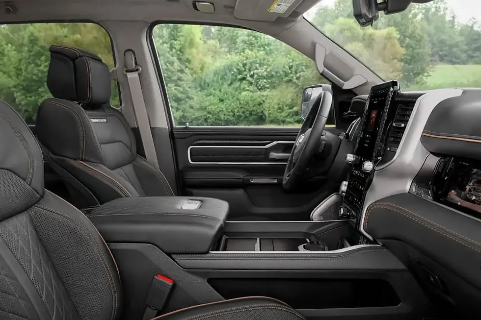 Ram 1500 cabin from the passenger side with quilted leather front seats and dashboard