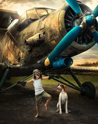 Un bambino col suo cane bracco italiano mentre giocano a fare gli aviatori.
