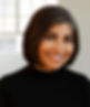 Smiling woman in black sweater poses in front of window. About Expat Senior Concierge CR