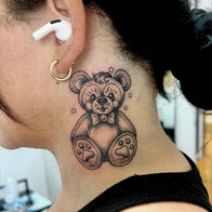 Black and grey ornamental teddy bear neck tattoo by Brianne