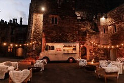 Food truck event in a castle courtyard at night