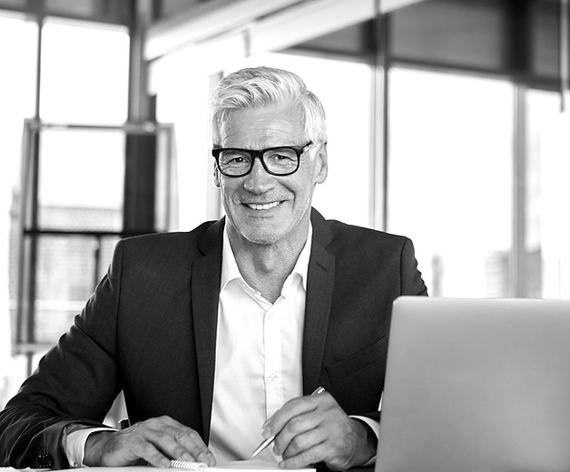 businessman-working-at-laptop-taking-not