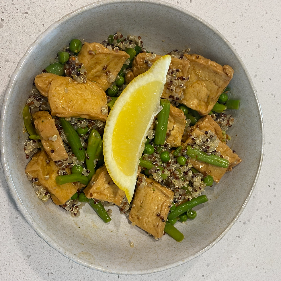 Quinoa bowl with tofu, green beans, peas, and lemon