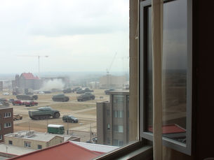 Destruction happening at a distance from a window.