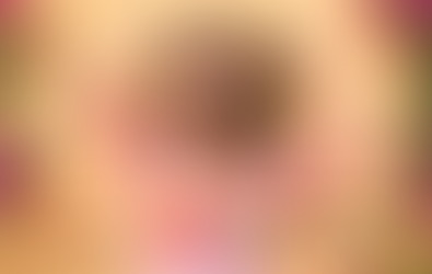 Smiling woman in pink dress poses with hands in curly hair on yellow backdrop; ad reads September’s for savings, up to 40%, Air Canada Vacations