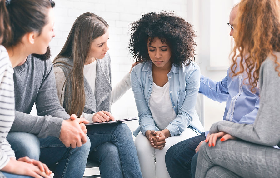 people in a circle supporting one another