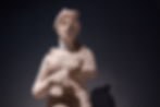 Ancient stone statue of a woman with missing arms, against a dark background. Features detailed hair, a serene expression, and soft shadows.