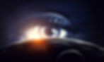 A large eye peers over a dark planet with a smaller moon. Sunlight glows at the horizon. The mood is mysterious and cosmic.