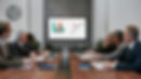 a group of people sitting around a conference table viewing a chart on a screen.