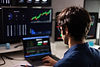 back-view-of-man-in-blue-shirt-working-with-multip-2026-01-07-02-16-02-utc.jpg