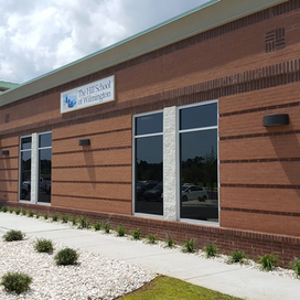 Front view of the red brick Hill School Wilmington building, showcasing the entrance and front office.