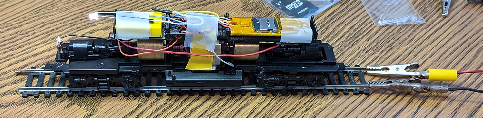 13. Summer 2021 LocoFi™ installation prior to the gray wire break. It is no wonder that the shell would not fit, i.e., excess wire on top of the platform and above the speaker, loose wires alongside of the motor, and liberal use of vinyl tape. Even cellophane tape is thicker than Kapton® tape.
