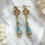 Thumbnail: Art Nouveau Style Turquoise and Gold Teardrop Earrings