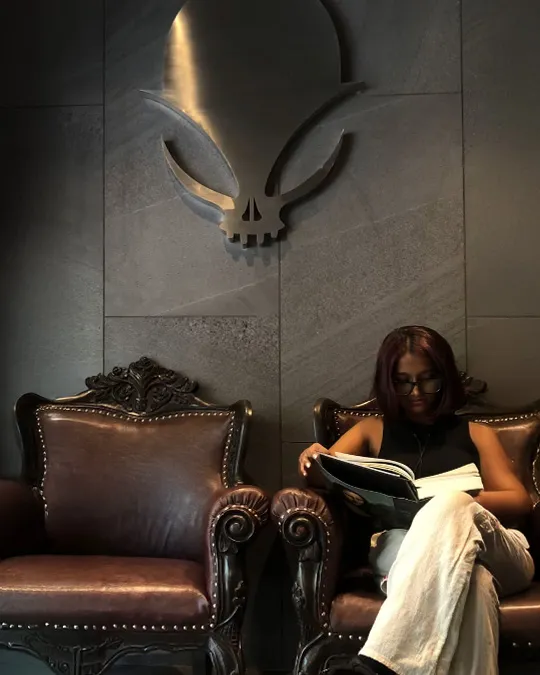 Sitting in tattoo studio lounge - Aliens Tattoo