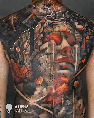 Full back tattoo of a classical stone face sculpture with geometric shapes, clouds and fiery accents in realistic style