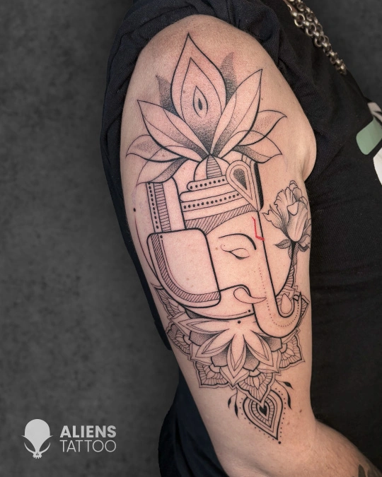 Fine line Lord Ganesha tattoo with lotus details done at the best tattoo studio in Hyderabad