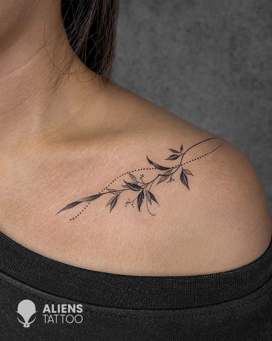 Delicate floral collarbone tattoo with fine line work at the best tattoo studio in Hyderabad